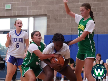 Girls basketball game in action.