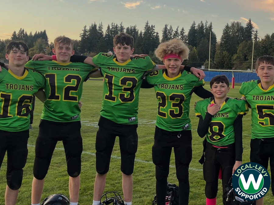 Boys football team arm in arm