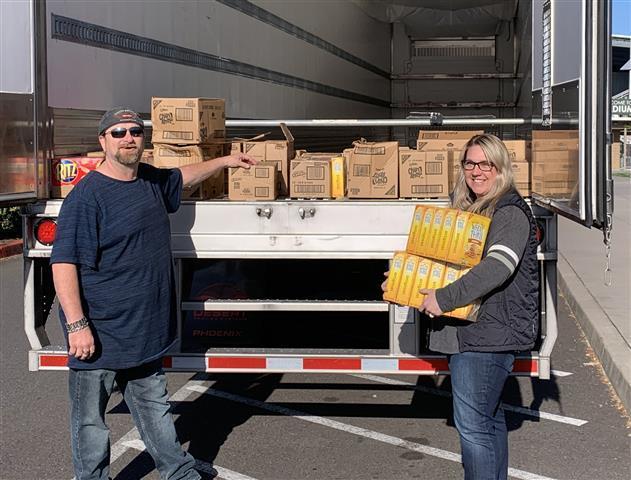 Shawn Fenmore, a driver with Landstar Ranger Trucking, drove 25 cases of unwanted cookies and crackers up to Woodland after his last stop in Vancouver to say thanks for Woodland Public Schools opening the high school as a temporary rest area for drivers during the closure