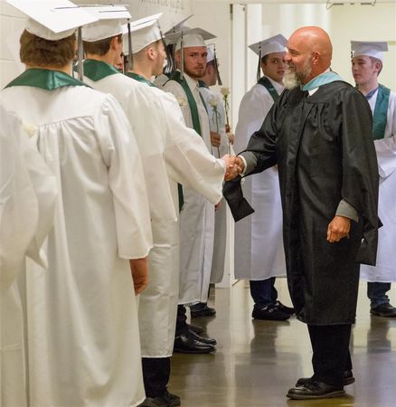 John Shoup shakes the hand of a senior from the class of 2019.