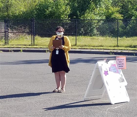 Nearly two dozen district employees helped make the plant sale happen like Stacy Gould pictured here wearing a mask while she checked in customers