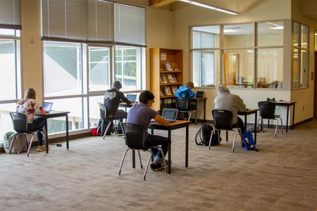 Students stay in bubble groups of around six students, wear masks, and practice social distancing to limit the spread of the virus