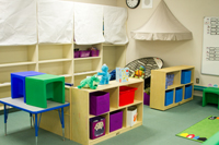 Colorful bins full of learning toys stacked neatly on a shelf