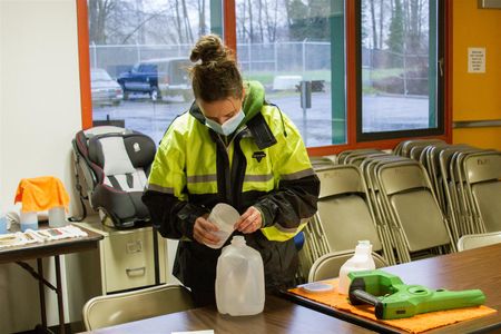 Mary Martin mixes the cleaning solution used in the electrostatic sprayers