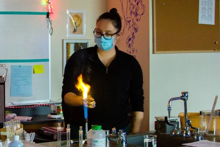 Stephanie Marshall, a high school science teacher, lights magnesium on fire to demonstrate chemical reactions during a recent science lab