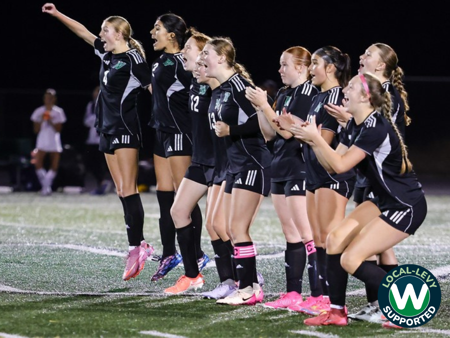 Girls soccer team cheering and clapping