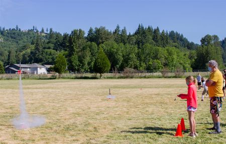 Retired teacher Leif Erickson supervises a student's rocket launch