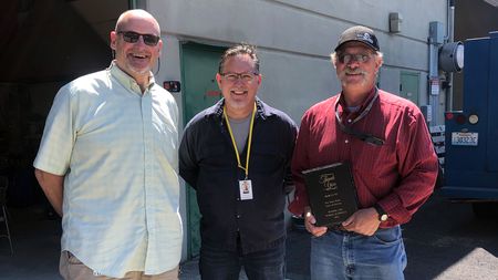 Superintendent Michael Green (left) and KWRL Director Shannon Barnett (center) celebrate with Bob Lute (right) on his retirement