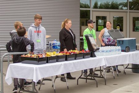 The district's Nutrition Services department provided free snacks (Director Laura Perry, far right, helps distribute snacks and water bottles)