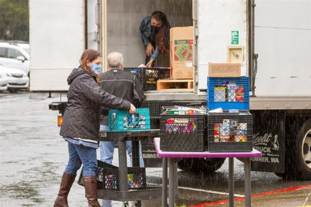 District admin Stacy Brown, Scott Landrigan, and Asha Riley helped collect and load the donations at each school