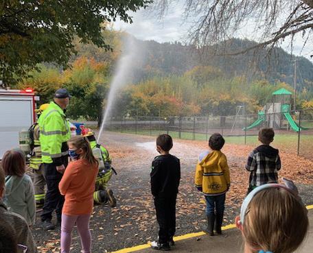 The firefighters bring different trucks and equipment, and spray fire-fighting foam on the parking lot so students can see how it all works