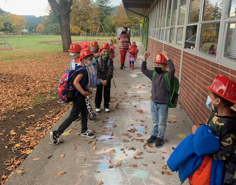 Each student receives a souvenir such as fire hats, fire badges, coloring books, stickers, and pencils