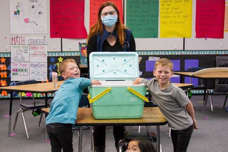 Students conducted an experiment using vegetable shortening and cold water to learn how a whale's blubber insulates the animal against the ocean's cold temperatures