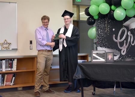 WHS Principal Phillip Pearson (left) congratulates 2022 grad Ian Wallace (right) on earning his diploma