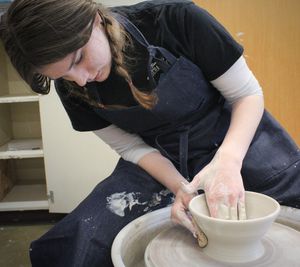 Image: Female student working on a pottery wheel