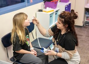 Image: Nurse assisting a student