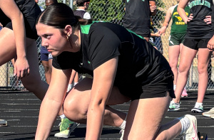 Image: Female middle school athlete at the start of a race