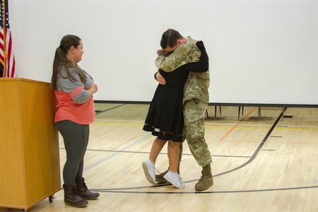 Abigail Alway, 8th grader at Woodland Middle School, was surprised during the Veterans Day assembly with the return of her uncle, Sergeant Edward Mayer II, who helped raise her