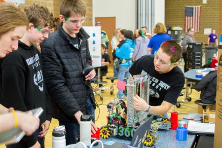 Team members rework and retool their robot after competing in a match