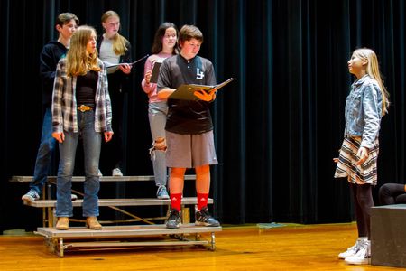 Lillia Andrews, an eighth grader (far right), enjoys the social camaraderie that comes from performing with friends