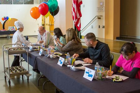 Dalton Feris, a 3rd grader, presents his Shrimp Salad recipe to the panel of judges