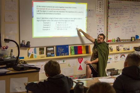 Matthew Kamel taught students how to perform mathematics using Roman numerals in the style of the Middle Ages