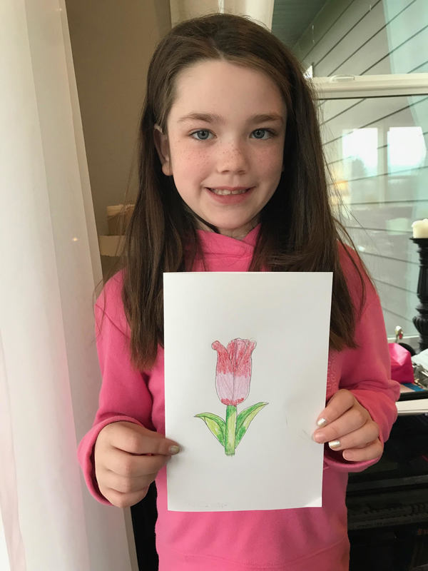 Scarlett holding up a hand drawn card