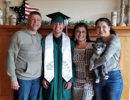 Asha Riley with husband Dave Riley (far left), son DJ Riley (left), daughter Leah Riley (right) and Tucker Riley (dog)