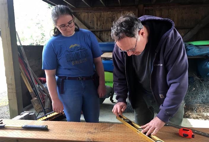 Mara using geometry to cut a piece of wood