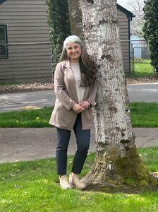 Superintendent Asha Riley leaning against a tree.