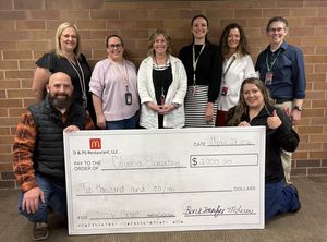 Teachers with a big check